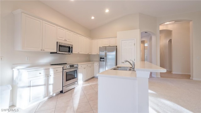 kitchen featuring sink, a kitchen island with sink, white cabinets, and appliances with stainless steel finishes