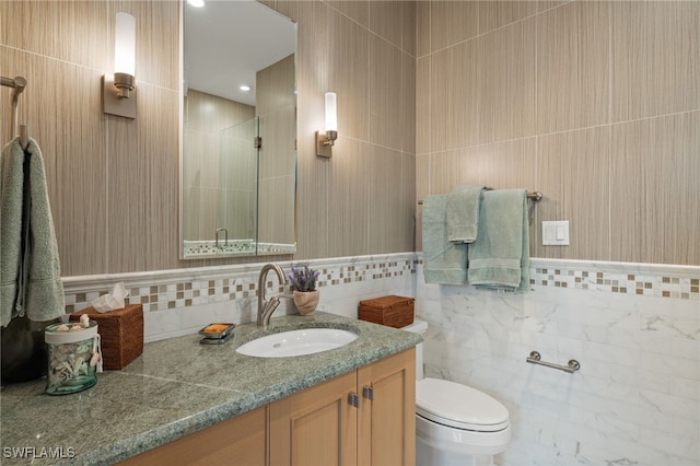 330 Cowry Ct, Sanibel, FL 33957 - full bathroom with toilet, vanity, a stall shower, and tile walls