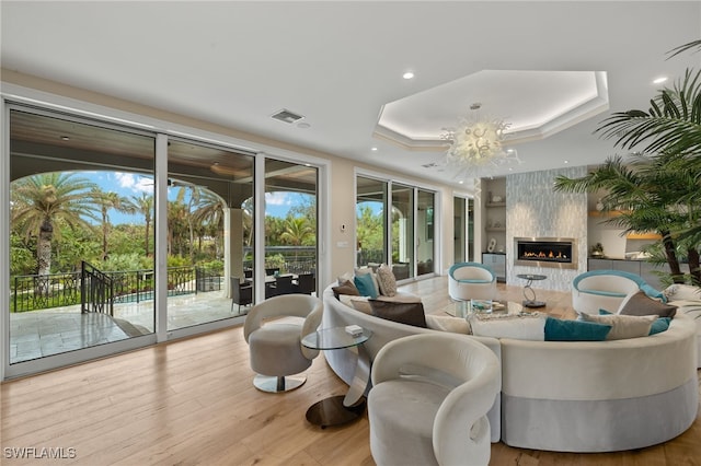 330 Cowry Ct, Sanibel, FL 33957 - living room featuring visible vents, wood finished floors, recessed lighting, a raised ceiling, and an inviting chandelier