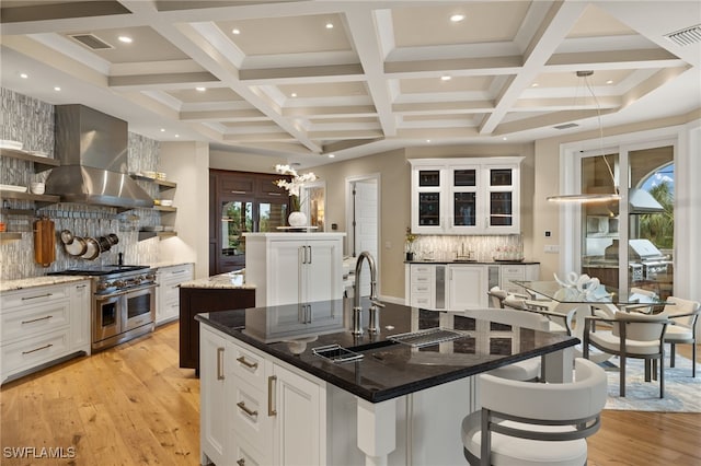 330 Cowry Ct, Sanibel, FL 33957 - kitchen with double oven range, island exhaust hood, light wood-style floors, a large island, and visible vents