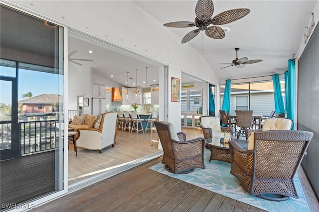 sunroom featuring vaulted ceiling and a ceiling fan