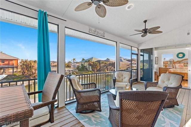 sunroom featuring vaulted ceiling and ceiling fan