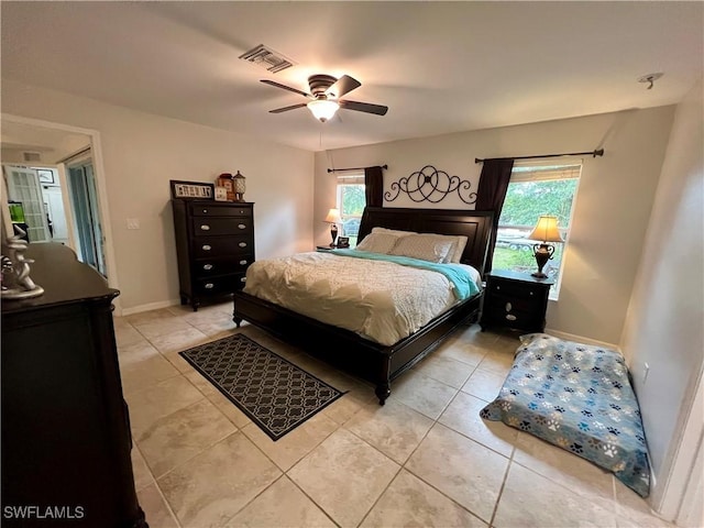 tiled bedroom featuring ceiling fan