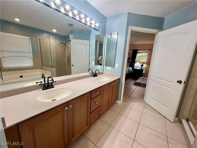 bathroom featuring vanity, tile patterned flooring, and plus walk in shower