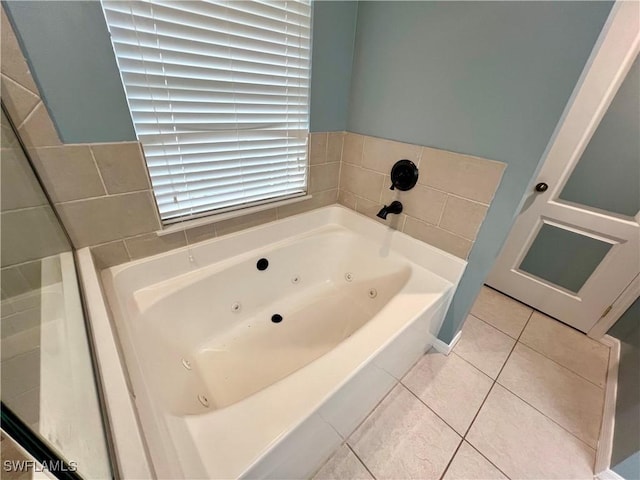 bathroom with tile patterned flooring and a bathing tub