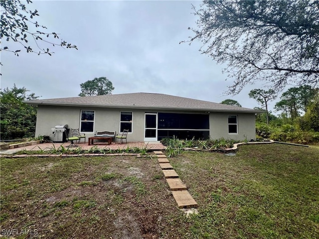 rear view of property featuring a yard and a patio