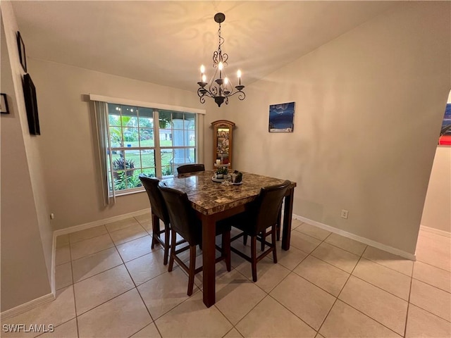 tiled dining area featuring an inviting chandelier