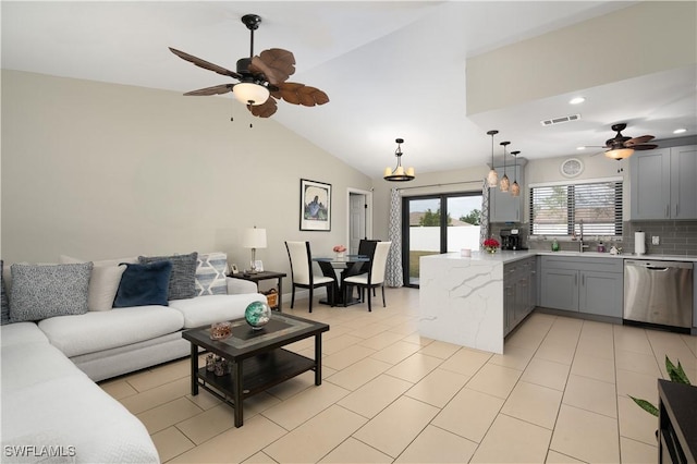 living room featuring vaulted ceiling, ceiling fan, light tile patterned flooring, and sink