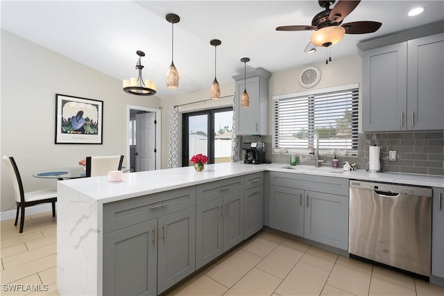 kitchen with stainless steel dishwasher, kitchen peninsula, sink, and gray cabinetry