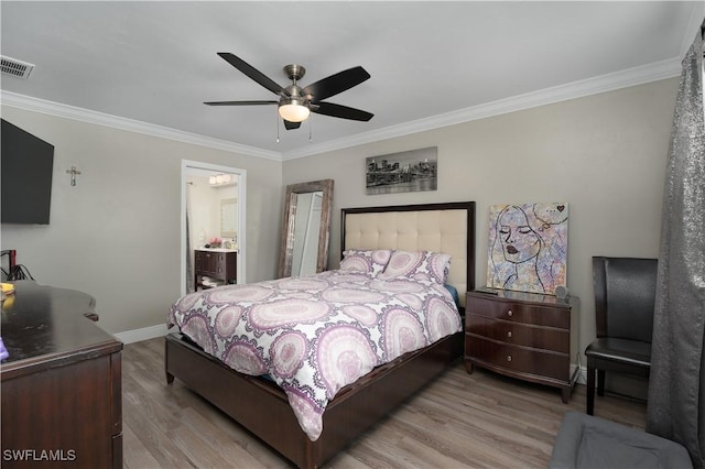 bedroom featuring ceiling fan, light wood-type flooring, connected bathroom, and ornamental molding