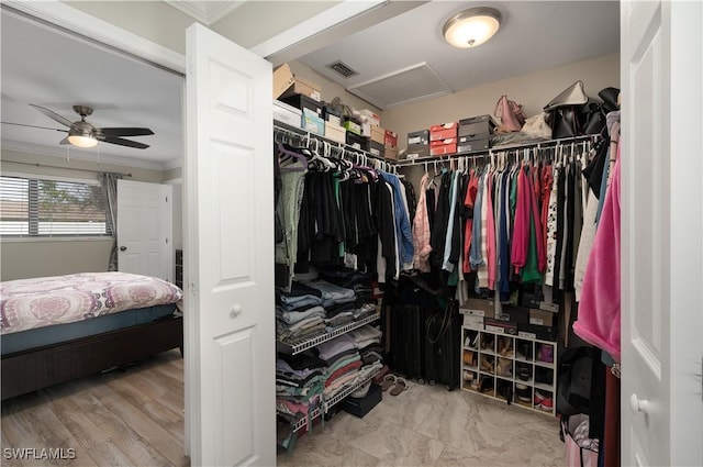 spacious closet with ceiling fan