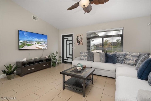 tiled living room with lofted ceiling and ceiling fan