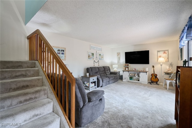 carpeted living room featuring a textured ceiling