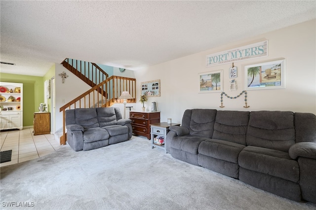 carpeted living room featuring a textured ceiling