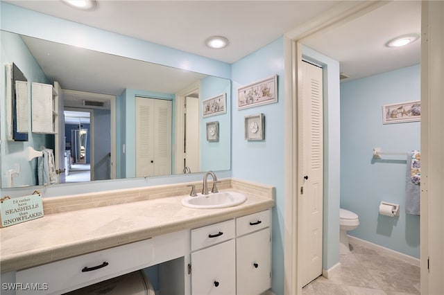 bathroom featuring toilet and vanity