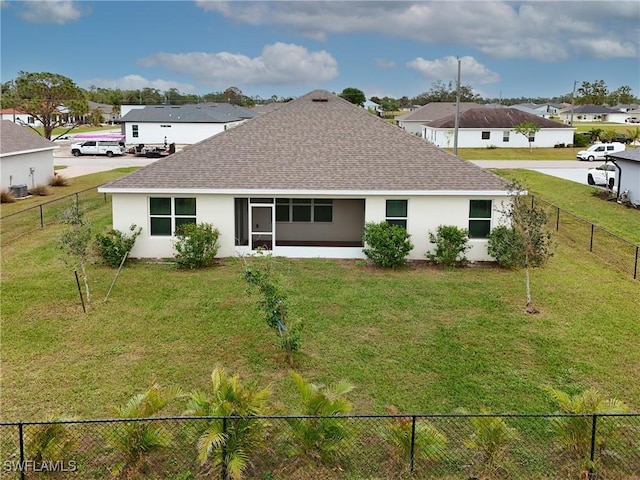 back of house with a lawn