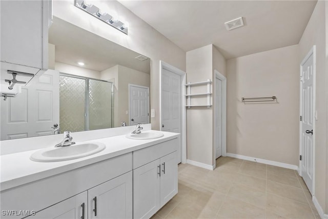 bathroom with an enclosed shower, tile patterned floors, and vanity