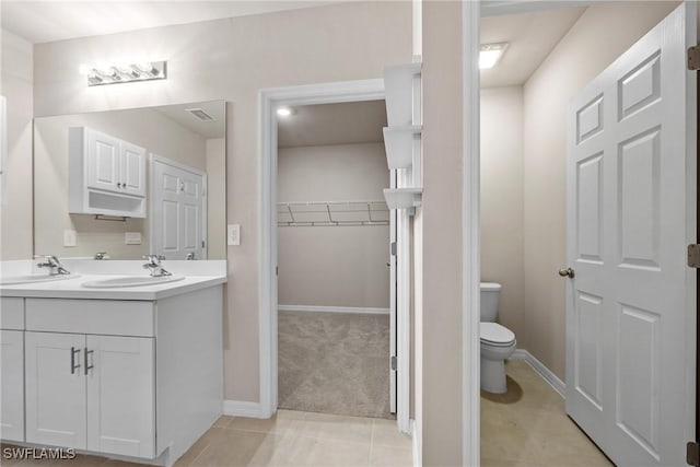 bathroom featuring vanity, toilet, and tile patterned flooring