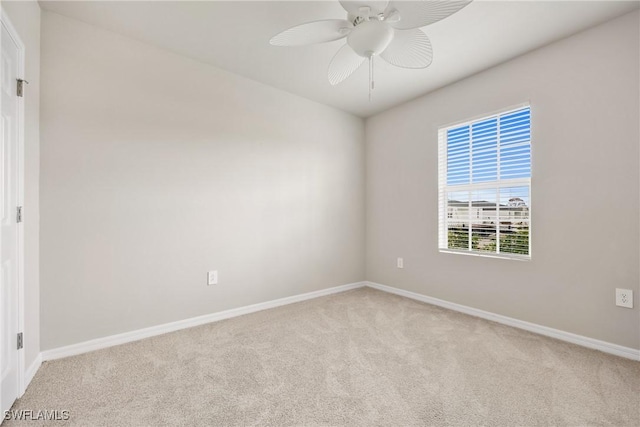 unfurnished room featuring ceiling fan and light colored carpet