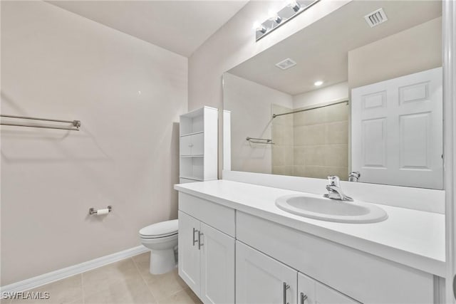 bathroom featuring toilet, tile patterned floors, a shower, and vanity