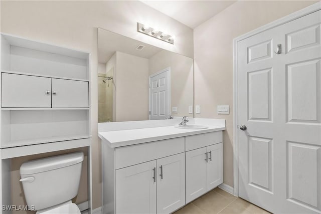 bathroom with toilet, tile patterned floors, and vanity