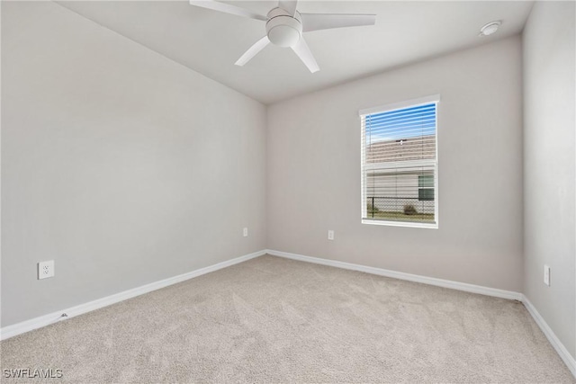 carpeted spare room featuring ceiling fan