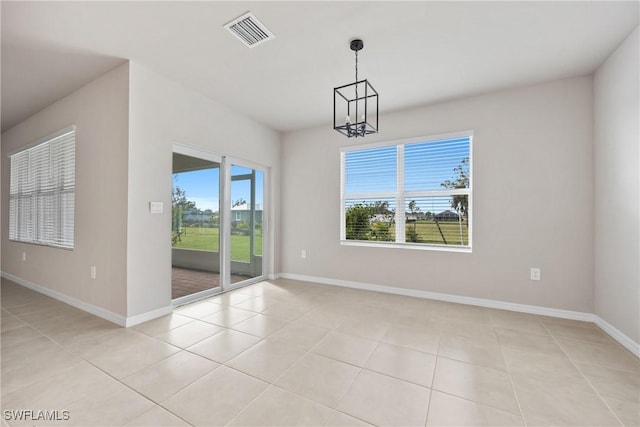 unfurnished dining area with a chandelier and light tile patterned floors