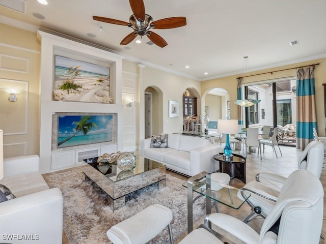 living room with ornamental molding, light tile patterned floors, and ceiling fan