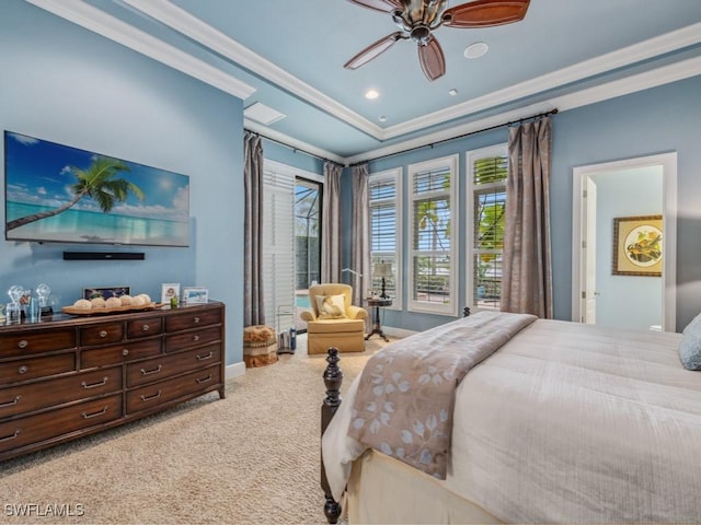 bedroom with ceiling fan, ornamental molding, a raised ceiling, and carpet floors