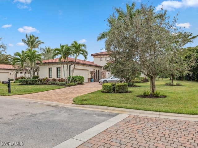 mediterranean / spanish home with a garage and a front yard