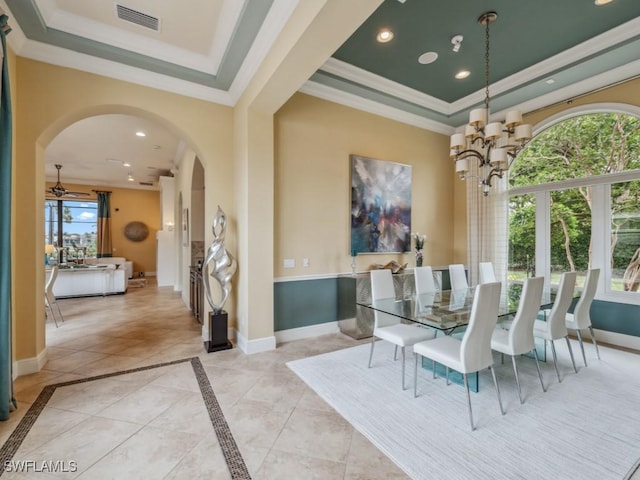 dining room featuring a tray ceiling, ornamental molding, and a chandelier