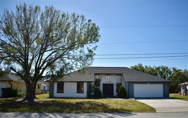 view of front of home with a garage and a front yard