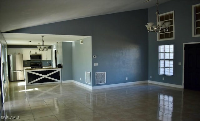 unfurnished living room featuring lofted ceiling, a notable chandelier, and sink