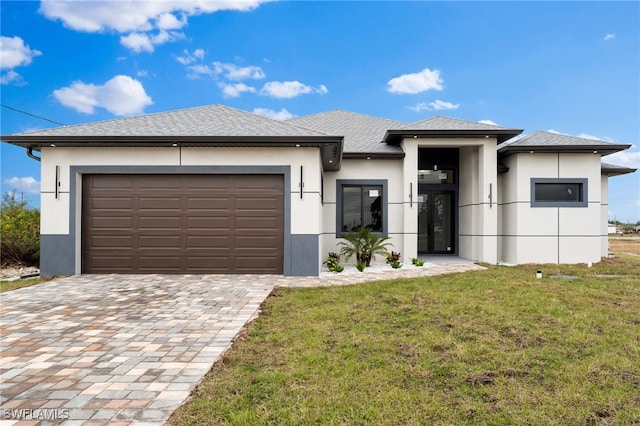 view of front facade with a front yard and a garage