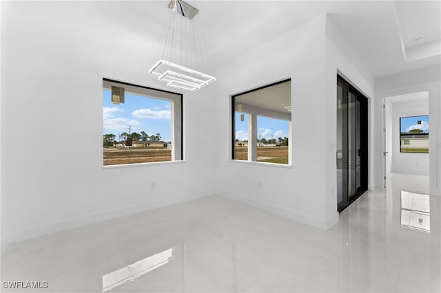 empty room featuring a chandelier