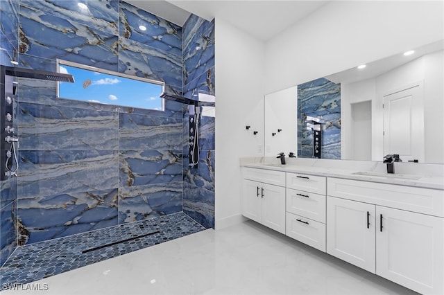 bathroom featuring tiled shower and vanity