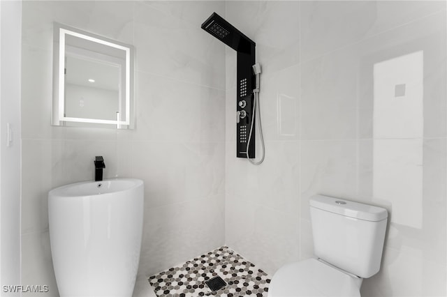 bathroom with toilet and tile walls