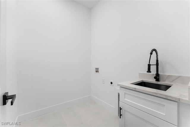 clothes washing area featuring cabinets, sink, hookup for a washing machine, and electric dryer hookup