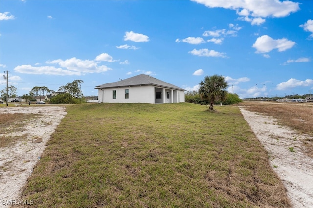 view of side of home with a lawn