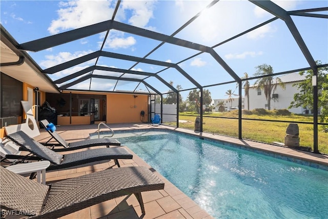 pool with a patio, a lawn, and a lanai