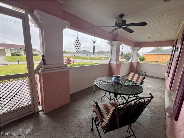 sunroom with ceiling fan and ornate columns