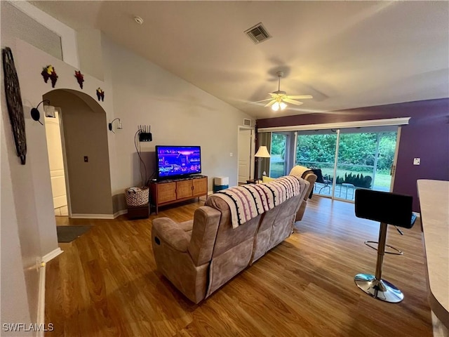 living room featuring ceiling fan, hardwood / wood-style floors, and lofted ceiling