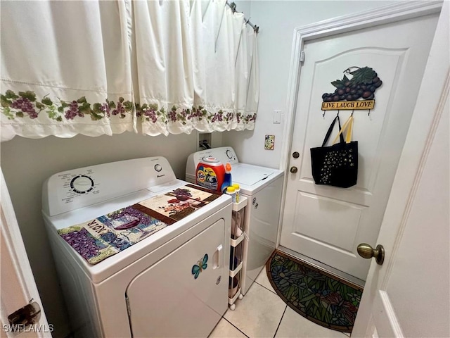 clothes washing area with separate washer and dryer and light tile patterned floors