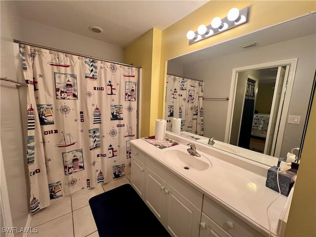 bathroom featuring walk in shower, tile patterned floors, and vanity