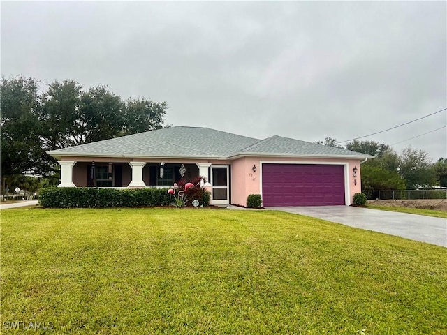 view of front of home with a front yard and a garage