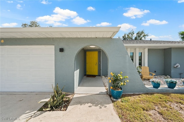 doorway to property with a garage