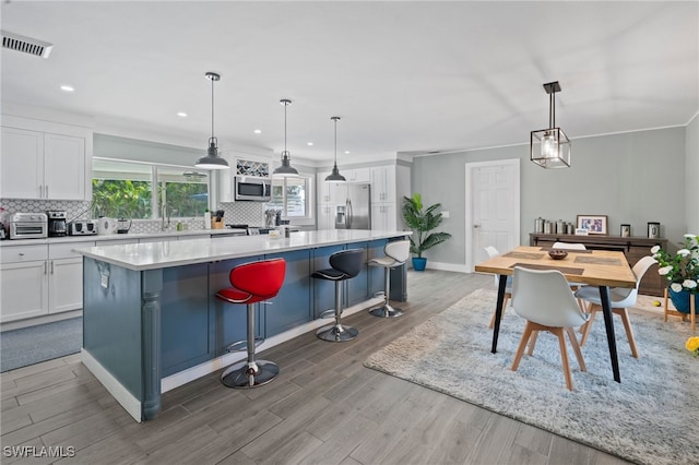 kitchen featuring white cabinets, appliances with stainless steel finishes, and a kitchen island