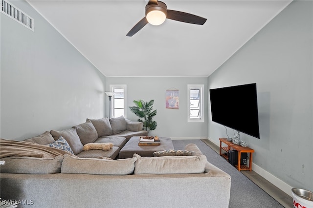 living room featuring carpet floors, vaulted ceiling, and ceiling fan