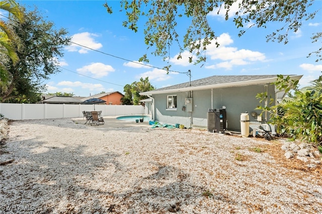 back of house featuring cooling unit and a patio