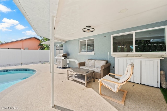 view of patio featuring a fenced in pool and grilling area